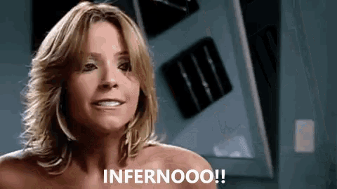 a naked woman says infernoo in front of a wall