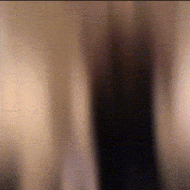 a blurred image of a person 's face with a black background