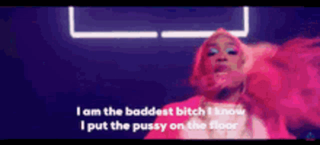 a woman in a pink coat is singing i am the baddest bitch i know i put the pussy on the floor .