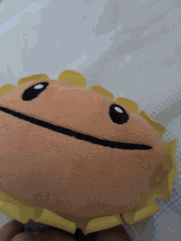 a stuffed sunflower with a black stripe on the face