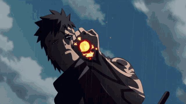 a man with a tattoo on his arm is holding a fireball