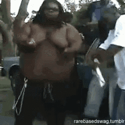 a group of people are standing around a very fat man .