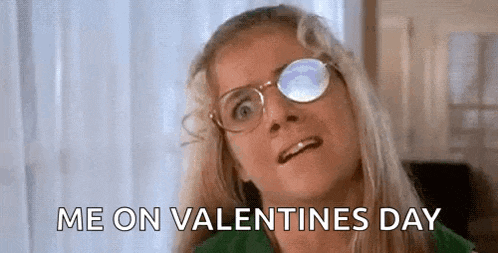 a woman wearing glasses is making a funny face and saying `` me on valentine 's day '' .