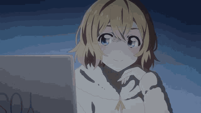 a girl is looking at a laptop with the word you written on it