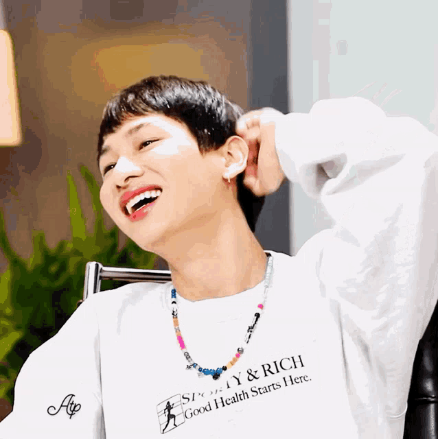 a man wearing a shirt that says sporty & rich on it