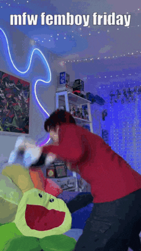a person is fighting a stuffed frog in a room with the words mfw femboy friday written on the bottom