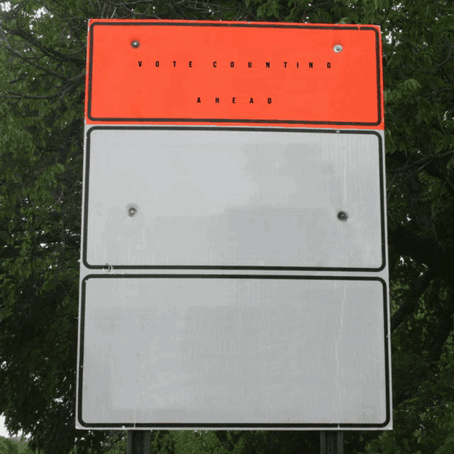 a sign that says vote counting ahead on the top