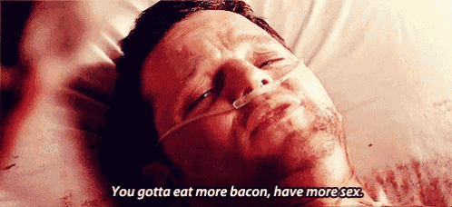 a man is laying in a hospital bed with an oxygen mask on his face and says you gotta eat more bacon have more sex .