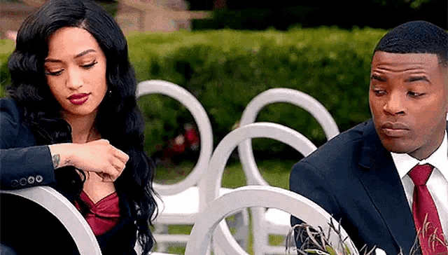 a man and a woman are sitting next to each other in a chair .