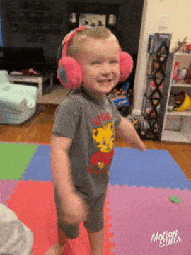a little boy wearing headphones and a shirt that says lucas the tiger
