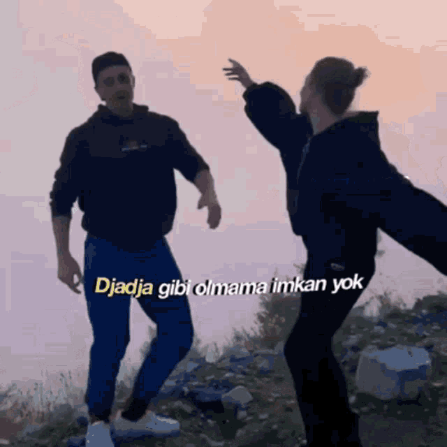 a man and a woman are dancing with the words djadja gibi olmama imkan yok written on the bottom