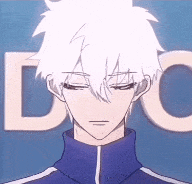 a man with white hair and a blue jacket stands in front of a blue background with the letter c visible