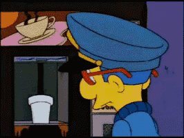 a cartoon character is looking at a cup of coffee in a machine