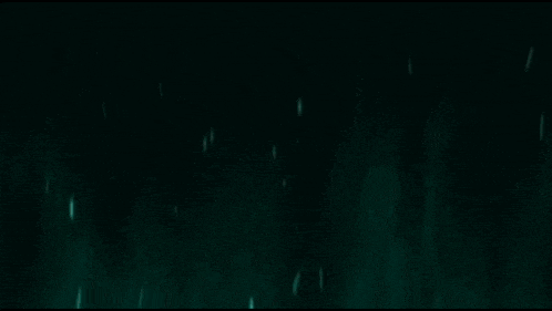 a green light is shining on a black background with the word x on it