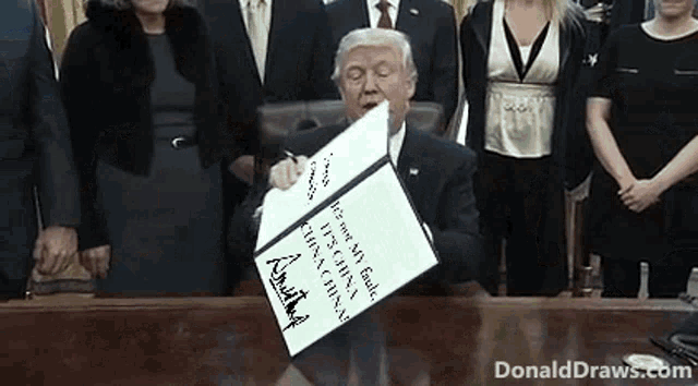 a man in a suit is signing a document with donald draws.com in the corner