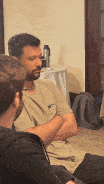 a man with a beard is talking to another man