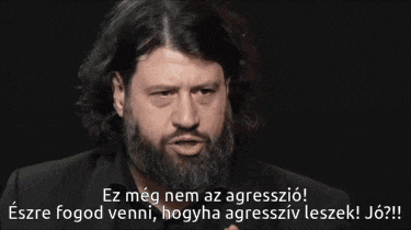 a man with a beard is talking in a foreign language