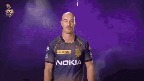 a man in a nokia shirt stands in front of a purple backdrop