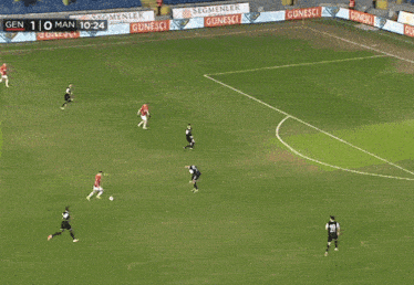 a soccer game is being played in a stadium and the score is 1-0