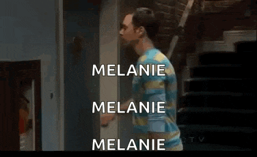 a man in a blue shirt is standing in front of a door with the words melanie and melanie written on it .