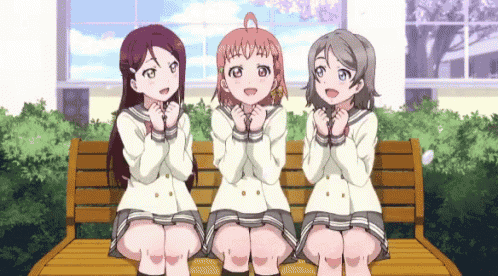 three anime girls are sitting on a bench with their hands on their faces