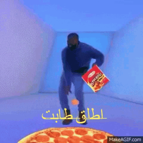 a man is standing in front of a pizza holding a bag of pepperoni chips .