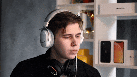 a man wearing headphones stands in front of a watch box