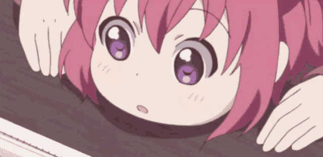 a little girl with pink hair and purple eyes is peeking over a table