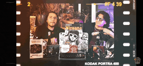 a kodak portra 400 film strip with two men and a nirvana album
