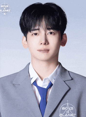 a young man is wearing a suit and tie with boys in planet written on his jacket