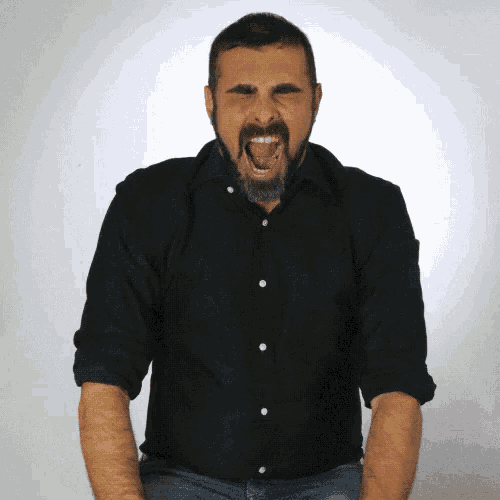 a man with a beard wearing a black shirt is making an angry face