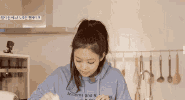 a woman wearing a hoodie that says unicorns and rays on it