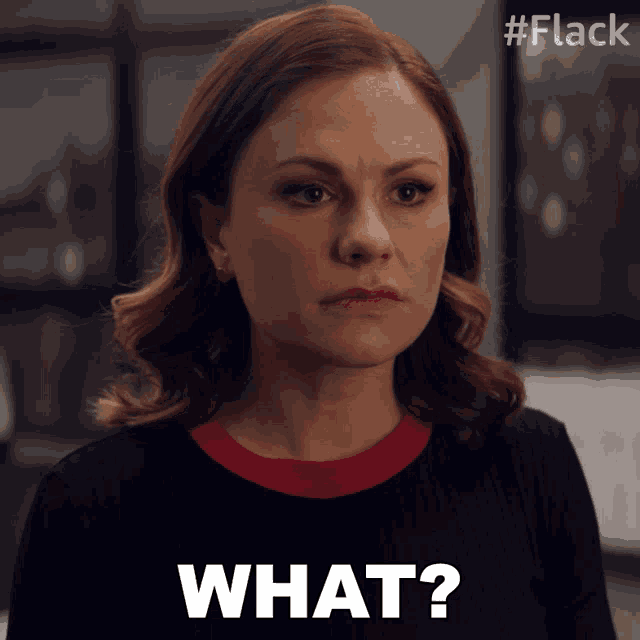 a woman in a black shirt says " what " in white letters