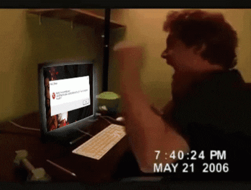 a man sitting in front of a computer with the time 7:40:24 pm