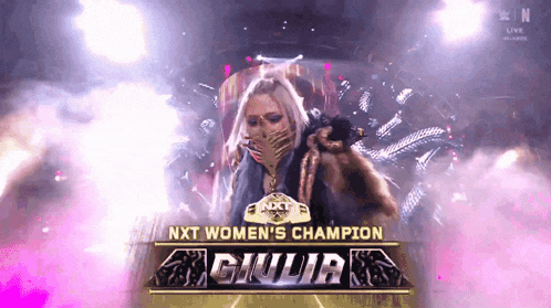 a woman is standing in front of a sign that says ' nxt women 's champion giulia '