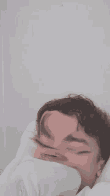 a blurry picture of a man 's face with a slight smile on his face