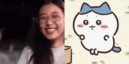 a woman wearing glasses is smiling next to a cat with a blue bow on its head .