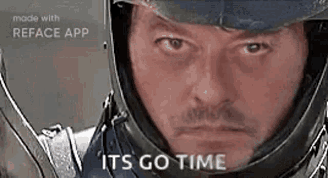 a man wearing a helmet and holding a sword is making a funny face .