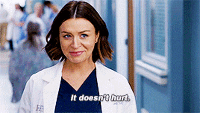a woman in a lab coat is smiling and says it does n't hurt .