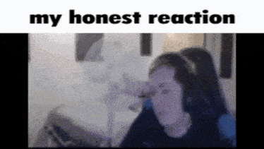 a woman wearing headphones is sitting in front of a fan with the words " my honest reaction " above her