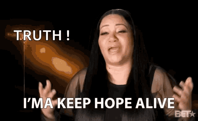 a woman is saying `` truth ! i 'm a keep hope alive '' while holding her hands in the air .