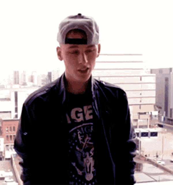 a young man wearing a black t-shirt that says age