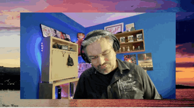 a man wearing headphones is in a room with the name hugo hope on the bottom left
