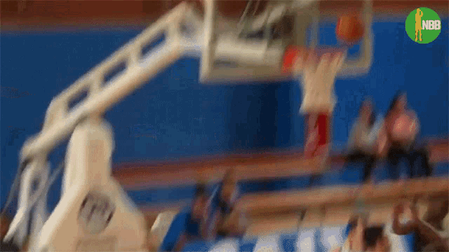 a blurry picture of a basketball game with the nba logo on the bottom right