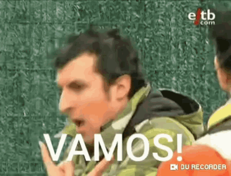 a man in a green jacket is saying vamos in spanish