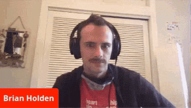 a man wearing headphones with the name brian holden on the bottom right