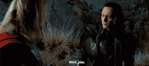 thor and loki are standing next to each other in a field .