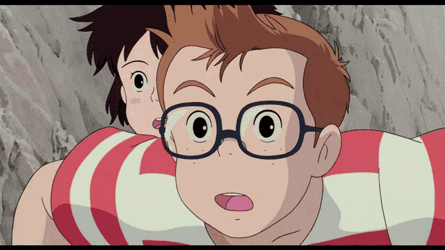a boy with glasses is carrying another boy on his back