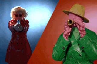 a woman in a red trench coat is pointing a gun at a man in a green trench coat