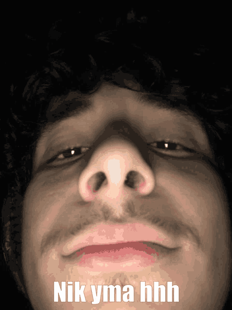 a close up of a man 's face with the words " nik yma hhh " above it